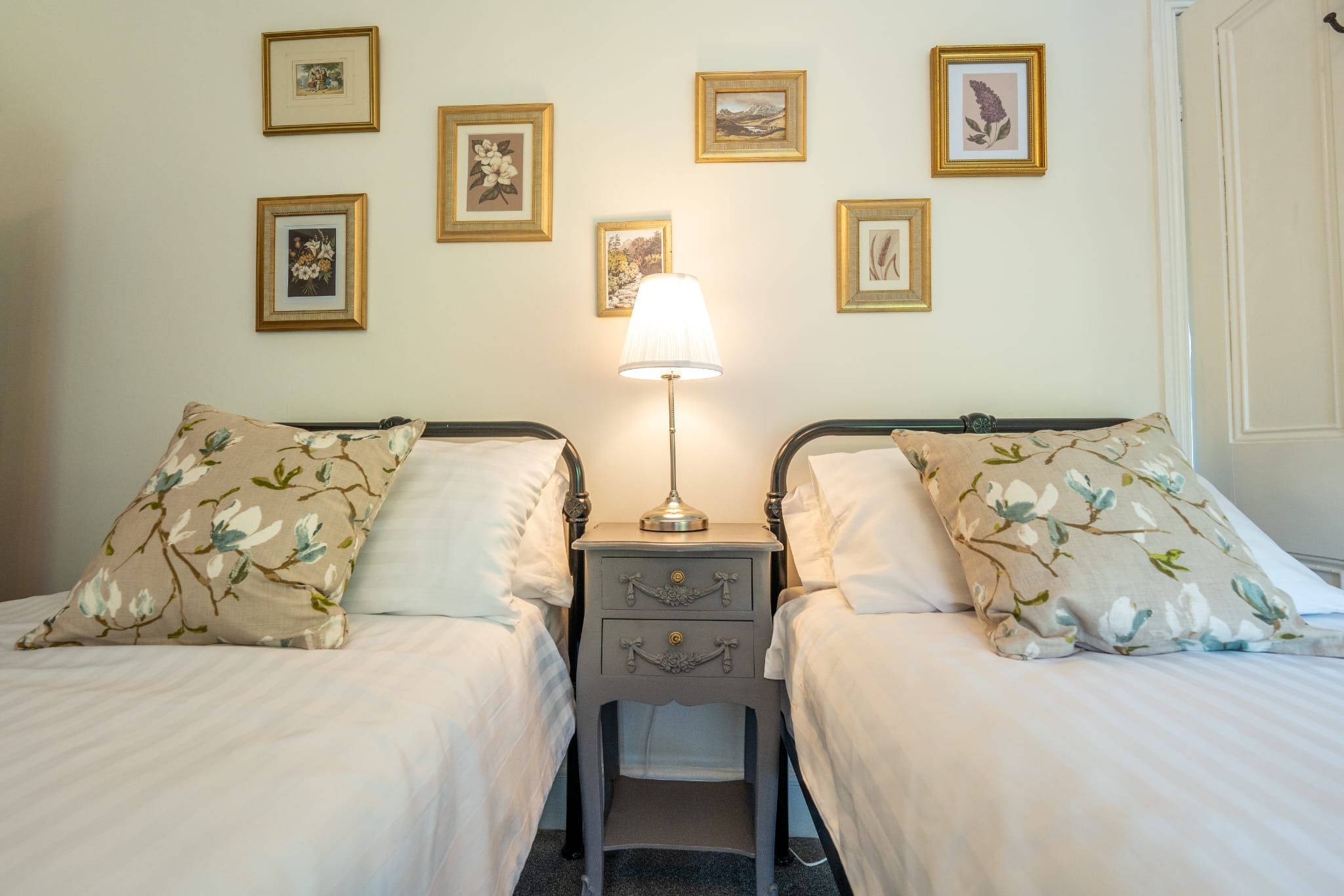 Twin bedroom, top floor, river-facing, with iron bedsteads